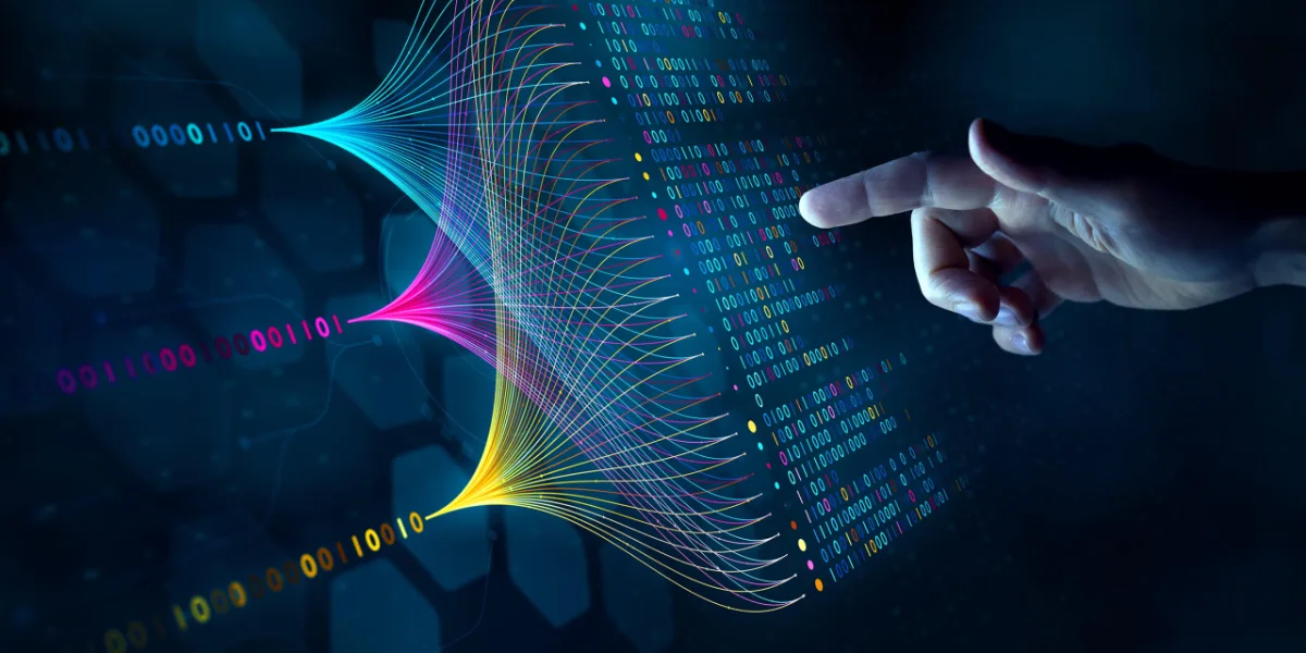 A hand touching a screen of streams of binary code converging into a data visualization